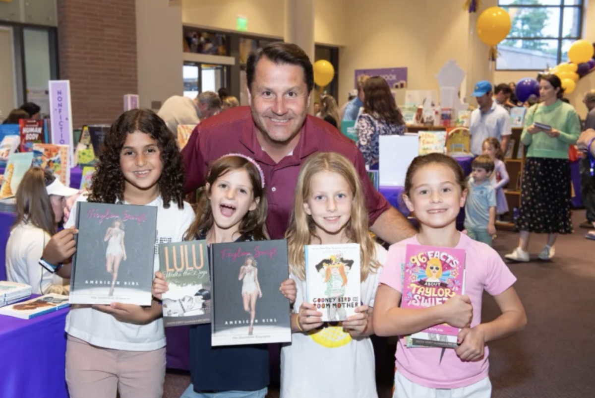 Mr. Jonathan Eades poses with a group of lower school students at Book Fair.